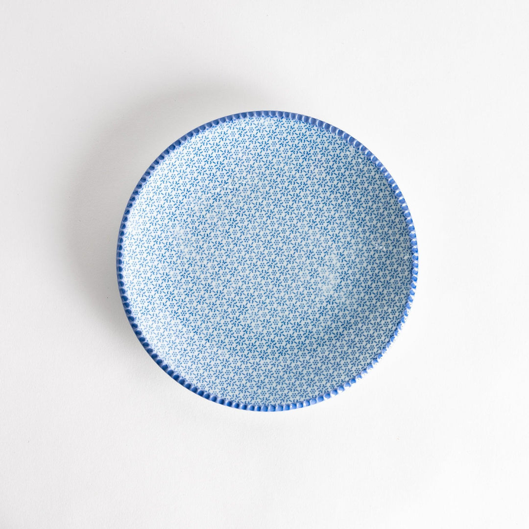 Japanese ceramic plate with delicate blue sesame pattern and intricate design adding elegance to dining.