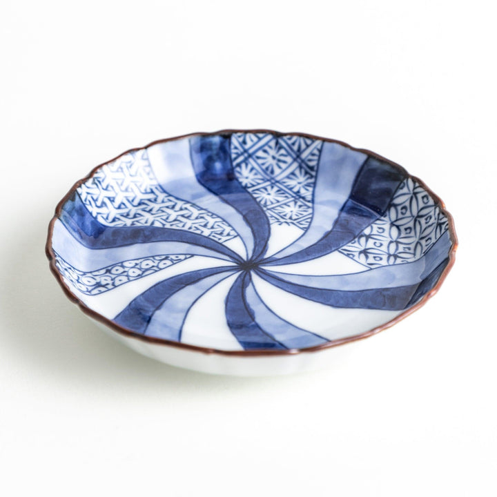 A small round plate featuring a blue swirl design with Mount Fuji background.