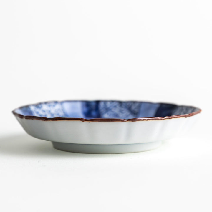 A small round plate featuring a blue swirl design with Mount Fuji background.