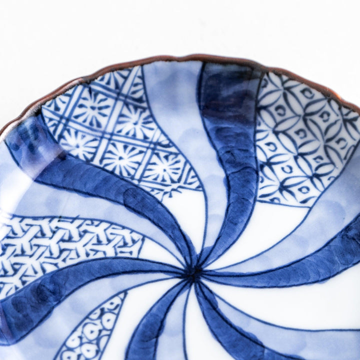 A small round plate featuring a blue swirl design with Mount Fuji background.