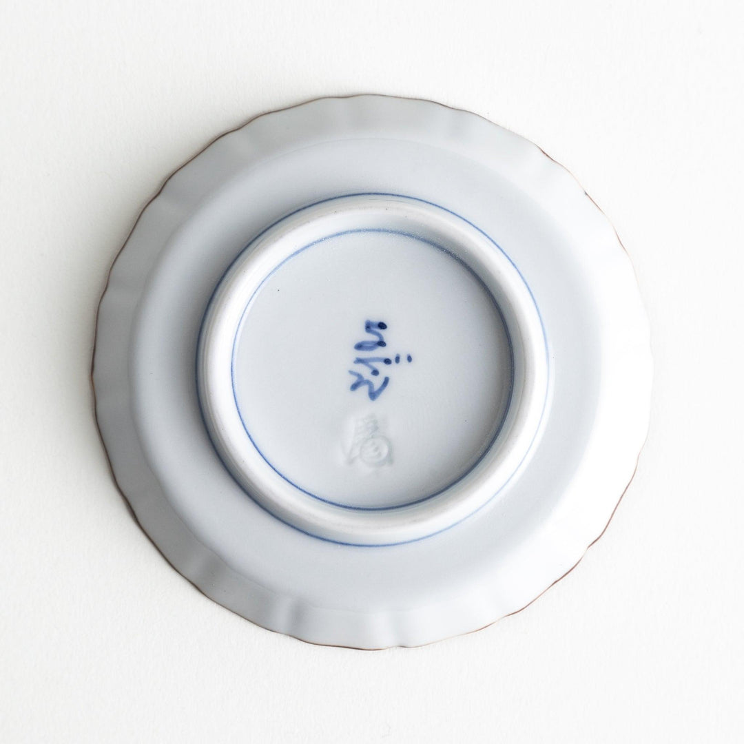 A small round plate featuring a blue swirl design with Mount Fuji background.