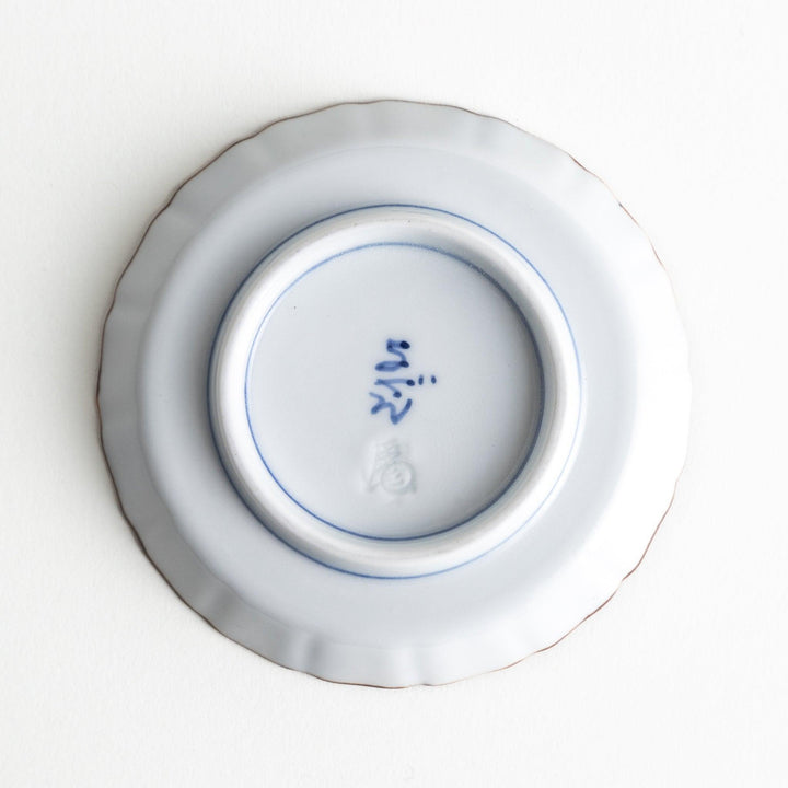 A small round plate featuring a blue swirl design with Mount Fuji background.