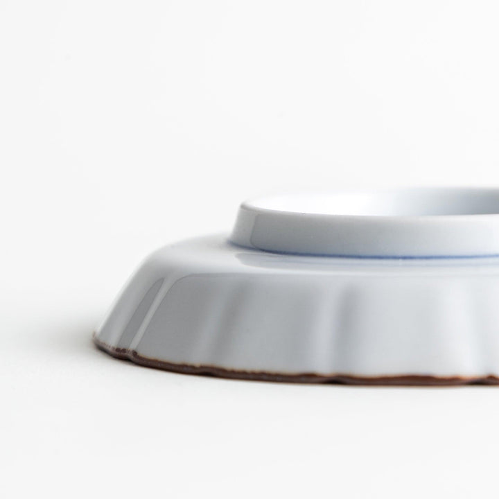 A small round plate featuring a blue swirl design with Mount Fuji background.