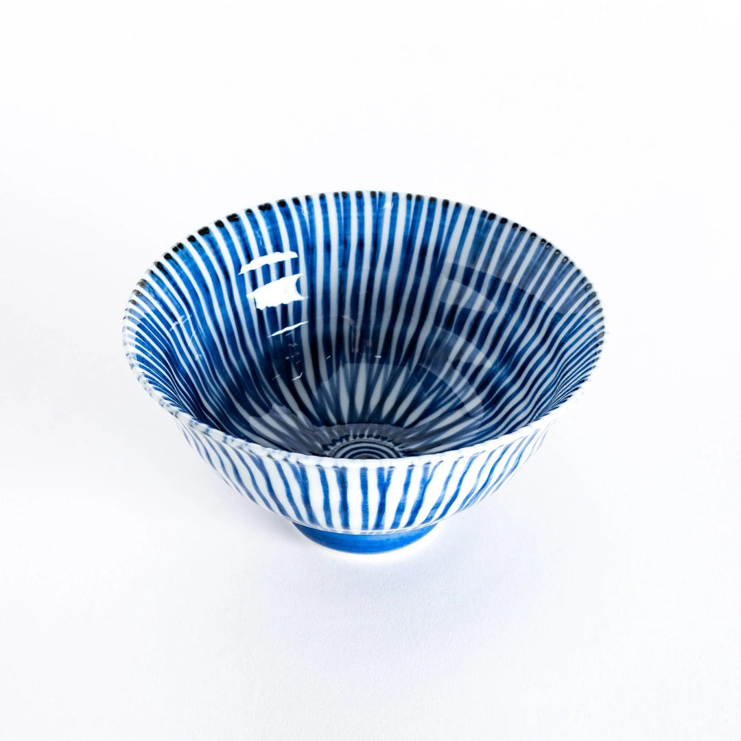 Slightly angled view of the blue-striped flared rice bowl, highlighting its elegant curves and striped pattern.