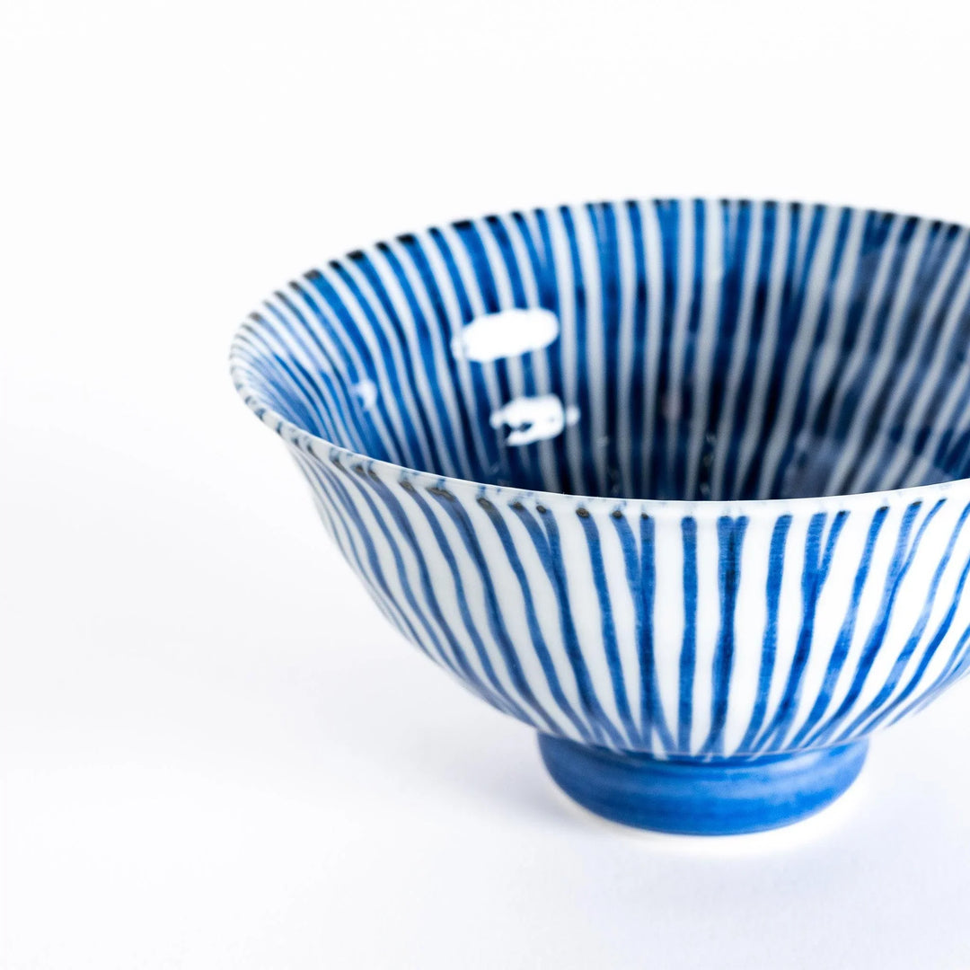 Close-up of the rice bowl's blue-striped pattern and smooth, glossy porcelain finish.