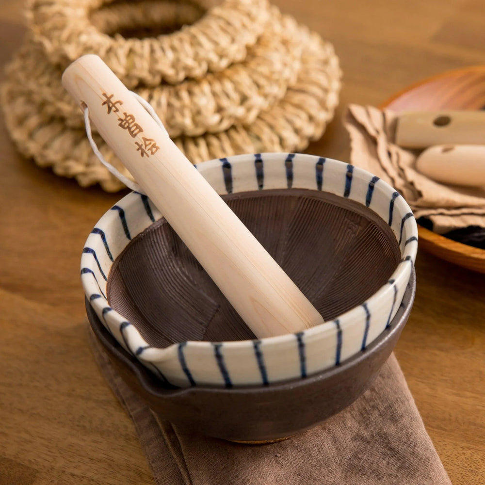 Hinoki wood pestle with engraved Japanese characters and cord for grinding seeds and spices with suribachi.