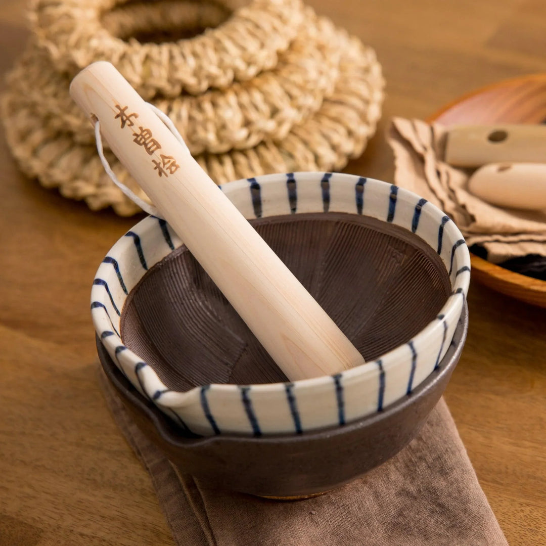 Hinoki wood pestle with engraved Japanese characters and cord for grinding seeds and spices with suribachi.
