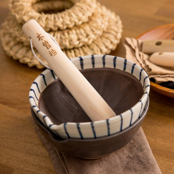 Hinoki wood pestle with engraved Japanese characters and cord for grinding seeds and spices with suribachi.