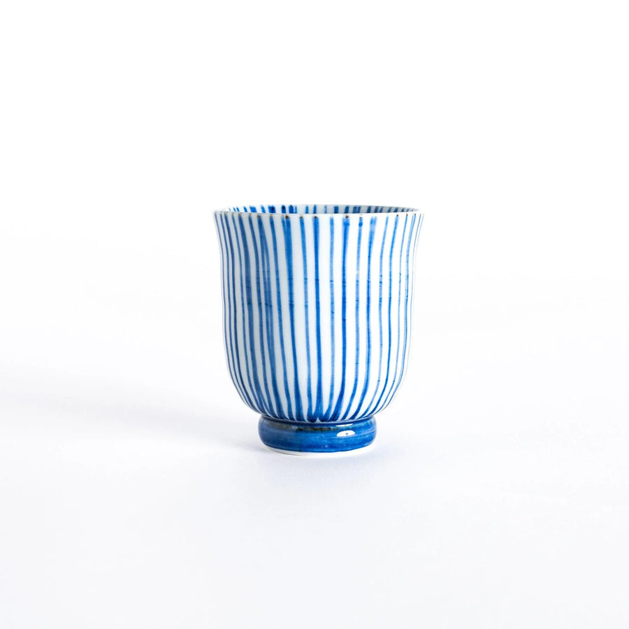 Front view of a blue-striped tea cup with vertical lines and a rounded base.