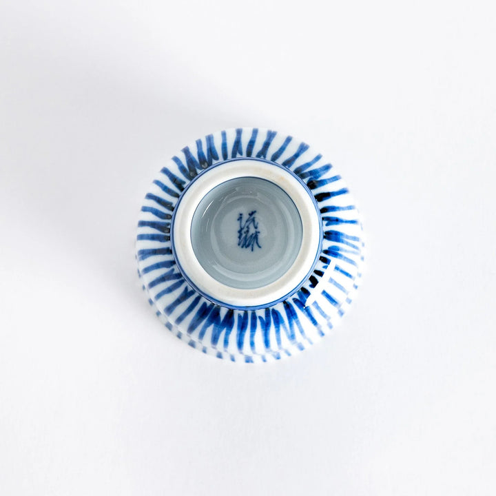 Bottom view of the tea cup showing the small, rounded base and the continuation of the blue stripe design.