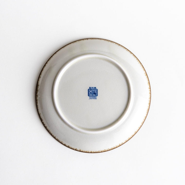 A blue and white salad plate with a concentric spiral pattern/