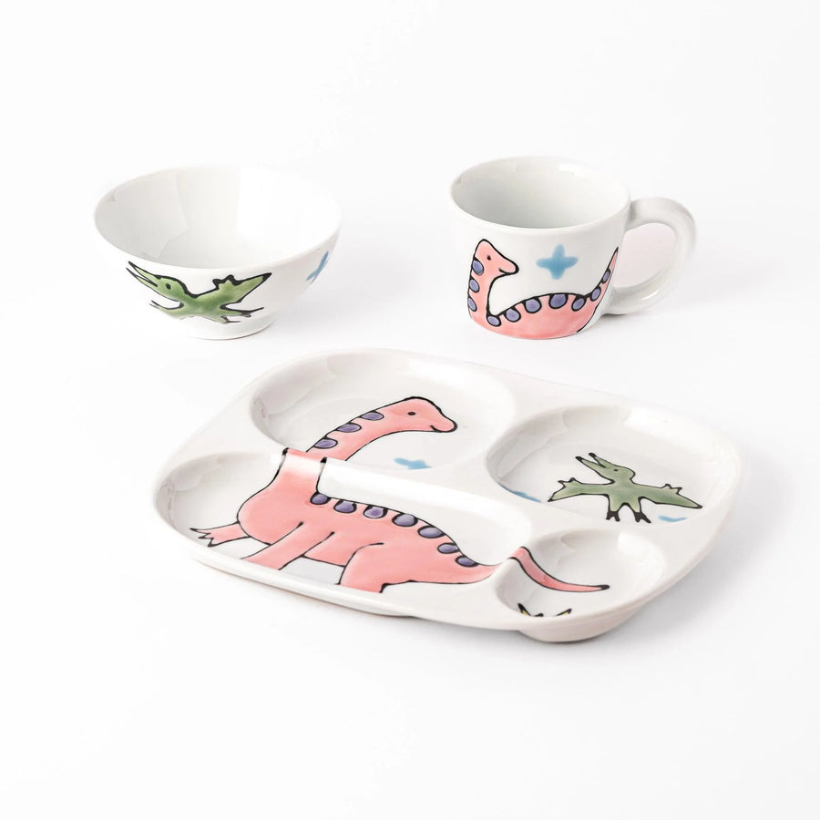 Kids dinosaur dining set with plate bowl and cup featuring pink Brachiosaurus and green flying dinosaur.