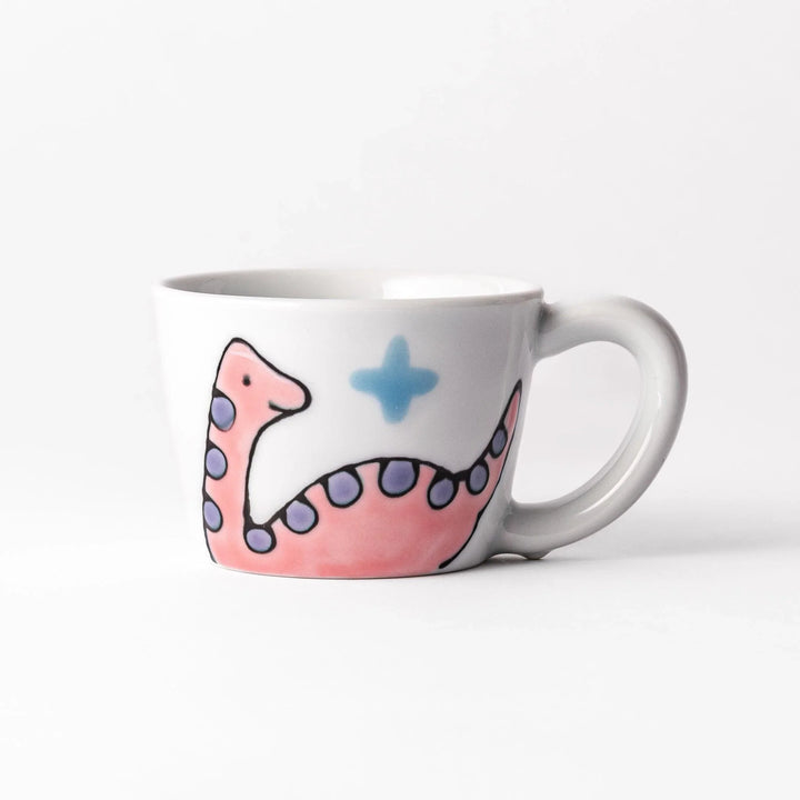 Kids' mug with a playful pink Brachiosaurus design, featuring purple spots and blue accents, perfect for adding a fun touch to your child's mealtime.