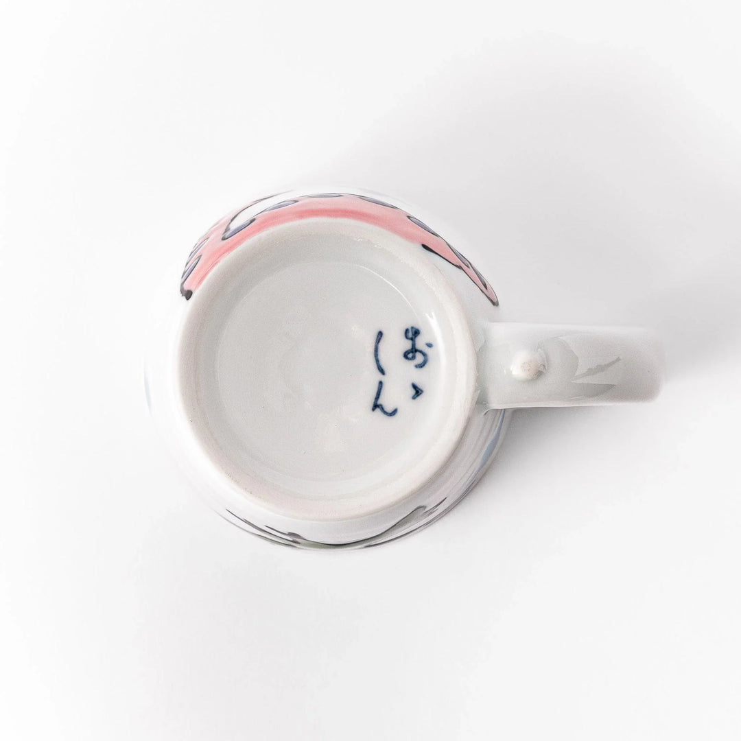 Kids' mug with a playful pink Brachiosaurus design, featuring purple spots and blue accents, perfect for adding a fun touch to your child's mealtime.