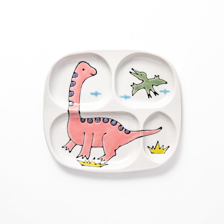 Japanese ceramic kids dinnerware set with pink dinosaur and green pterodactyl design including plate bowl and mug.