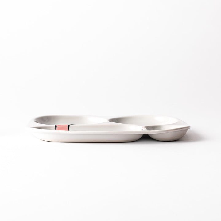 Japanese ceramic kids dinnerware set with pink dinosaur and green pterodactyl design including plate bowl and mug.