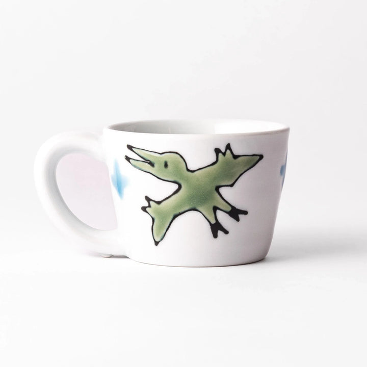 Kids’ mug with pink Brachiosaurus and purple spots, adding a playful touch to children’s mealtime.