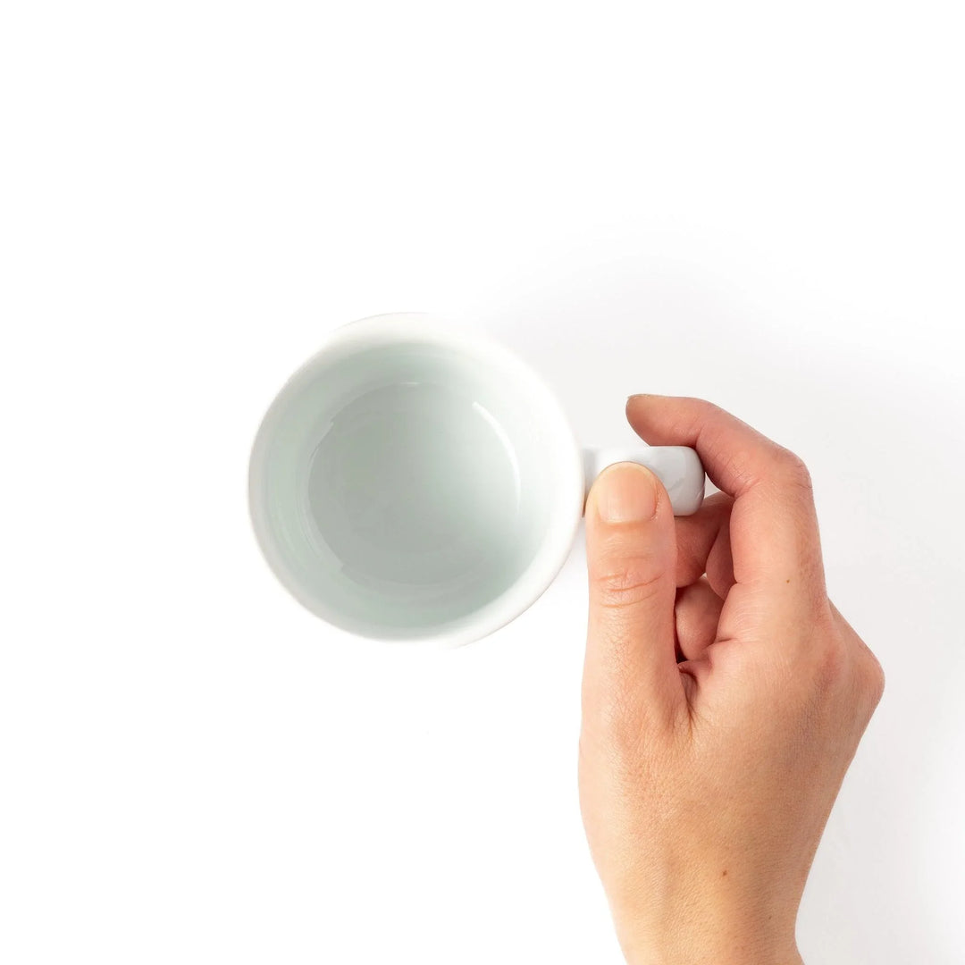 Kids’ mug with pink Brachiosaurus and purple spots, adding a playful touch to children’s mealtime.