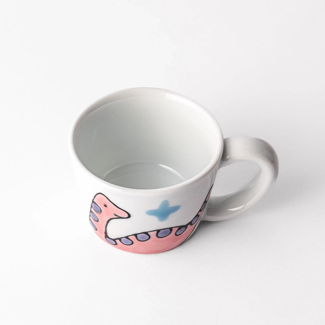 Kids’ mug with pink Brachiosaurus and purple spots, adding a playful touch to children’s mealtime.