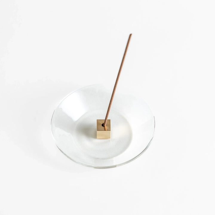 Glass and brass incense holder set combining modern design and function for elegant incense display.