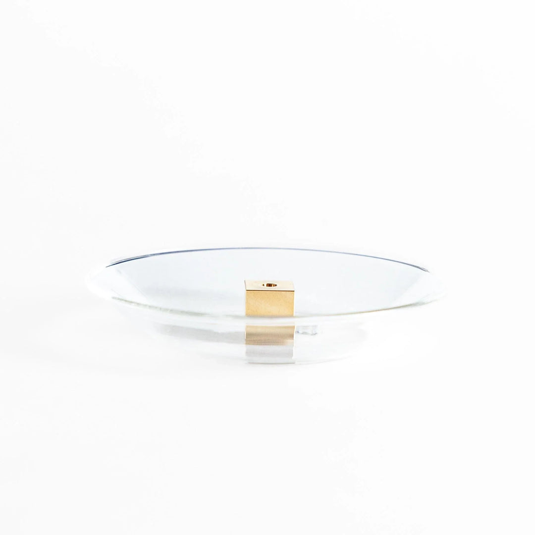 Glass and brass incense holder set combining modern design and function for elegant incense display.