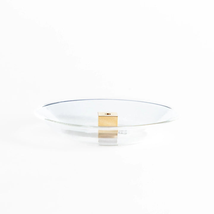 Glass and brass incense holder set combining modern design and function for elegant incense display.