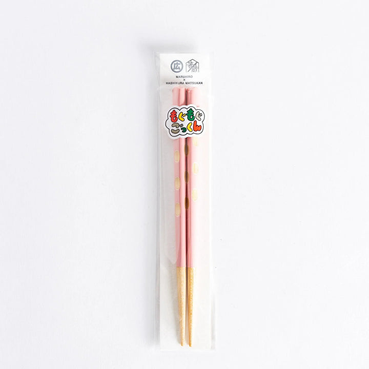 Pink children’s chopsticks with wood tips, packaged in a transparent bag.