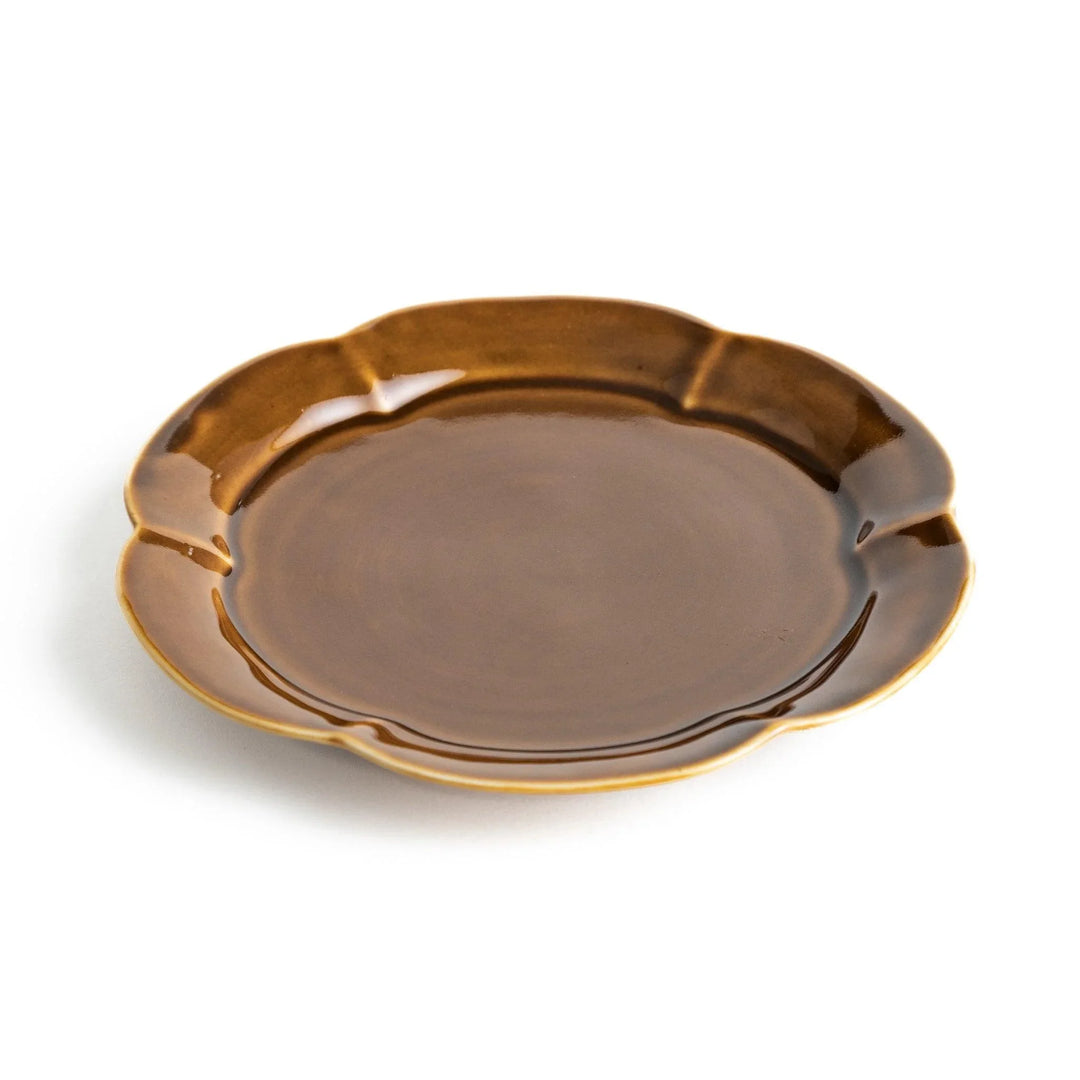 Earthy tones of olive, caramel, or off-white dessert plate, with a soft, rounded shape and subtle color variations.