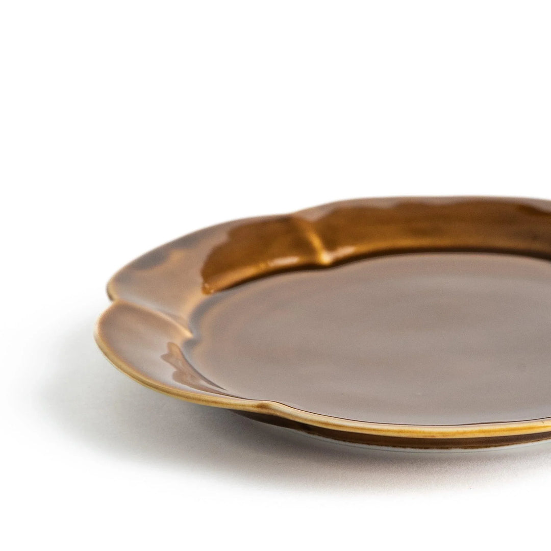 Earthy tones of olive, caramel, or off-white dessert plate, with a soft, rounded shape and subtle color variations.