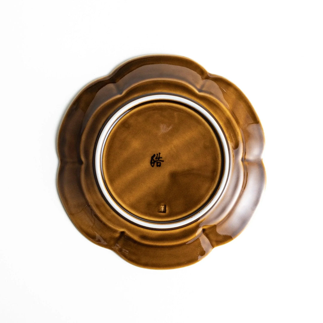 Earthy tones of olive, caramel, or off-white dessert plate, with a soft, rounded shape and subtle color variations.