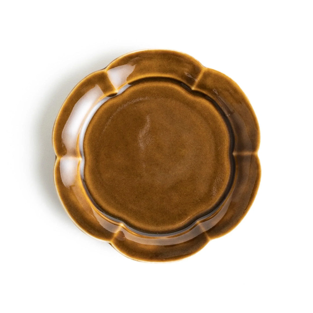 Small flower-shaped sauce dish in green, brown, and white.