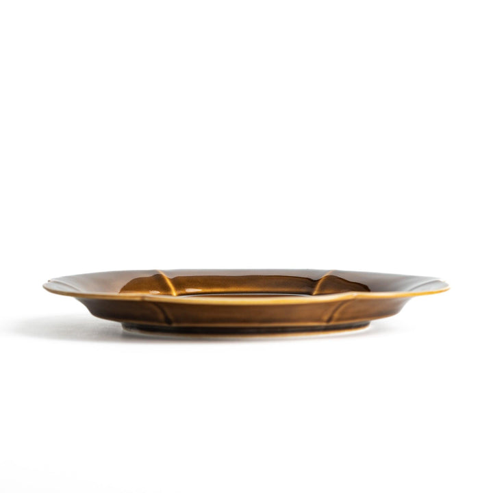 Earthy tones of olive, caramel, or off-white salad plate, with a soft, rounded shape and subtle color variations.