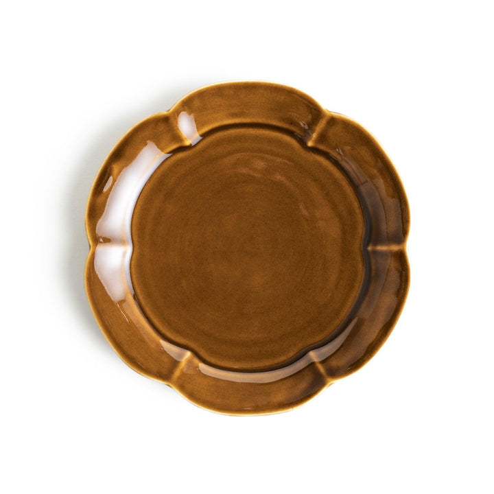 Earthy tones of olive, caramel, or off-white dessert plate, with a soft, rounded shape and subtle color variations.