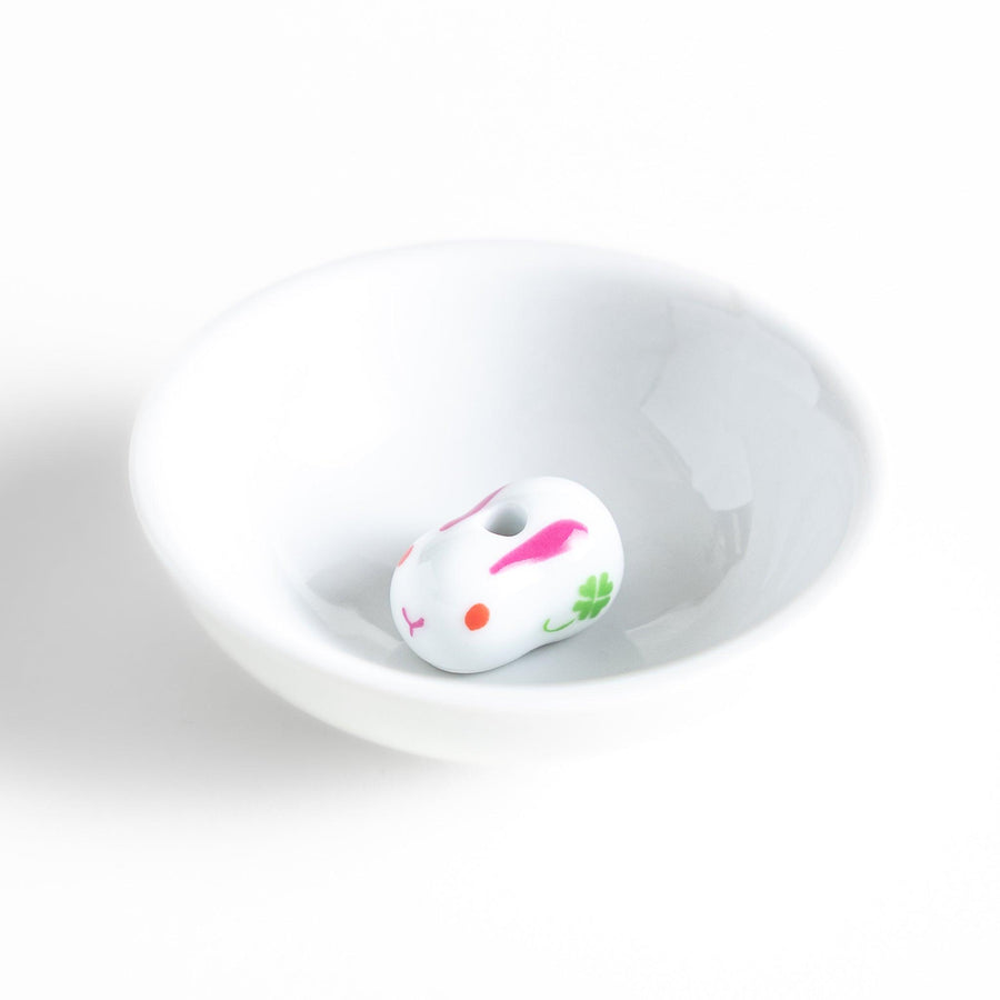 Japanese ceramic bunny incense holder set with small white dish and cute pink and green rabbit charm design.