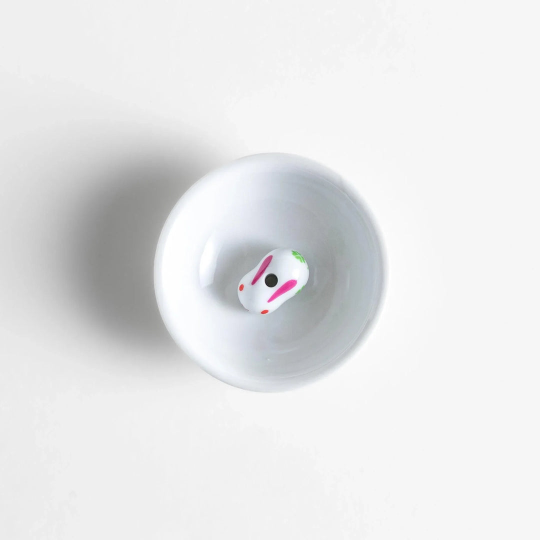 Japanese ceramic bunny incense holder set with small white dish and cute pink and green rabbit charm design.