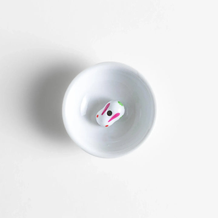 Japanese ceramic bunny incense holder set with small white dish and cute pink and green rabbit charm design.