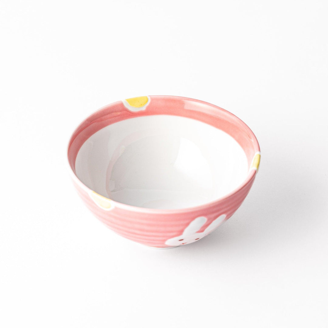 Charming pink kids' rice bowl featuring a cute bunny illustration and yellow accents, perfect for adding a playful touch to mealtime.
