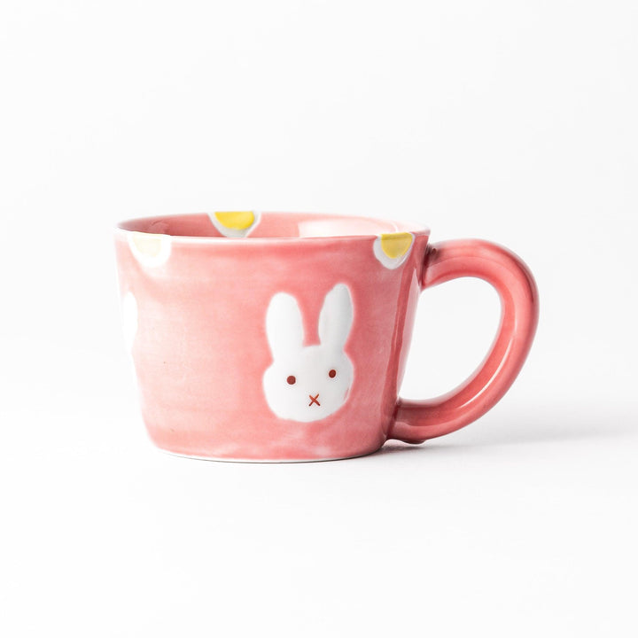 Adorable pink kids' mug featuring a cute bunny design and yellow accents, perfect for young children and adding a fun touch to mealtime.