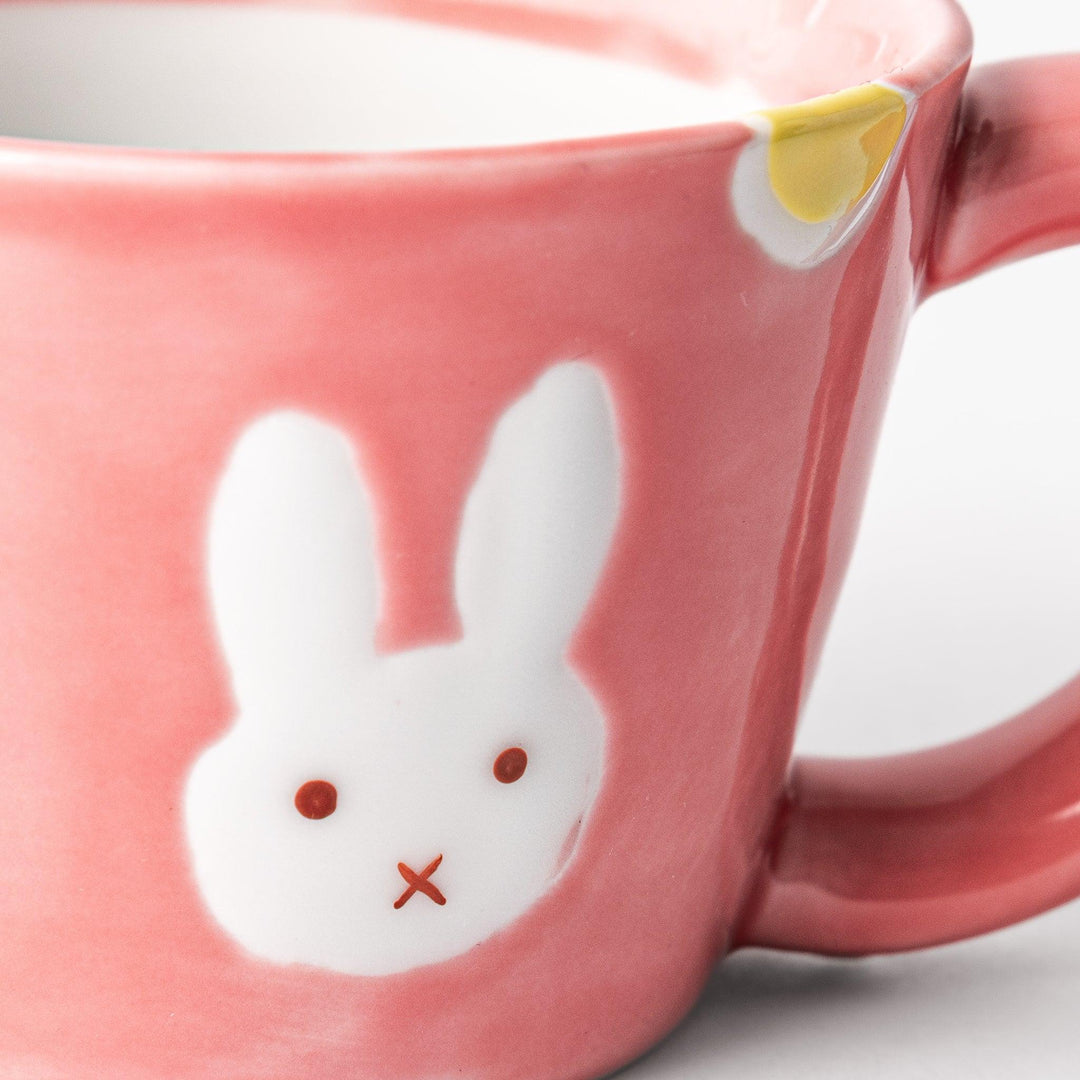 Adorable pink kids' mug featuring a cute bunny design and yellow accents, perfect for young children and adding a fun touch to mealtime.