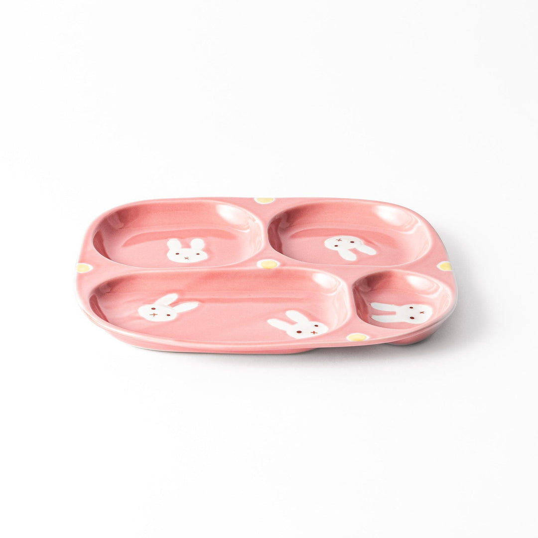 Adorable bunny-themed kids' plate featuring four sections, each with a cute bunny illustration, set in a cheerful pink color with yellow accents.