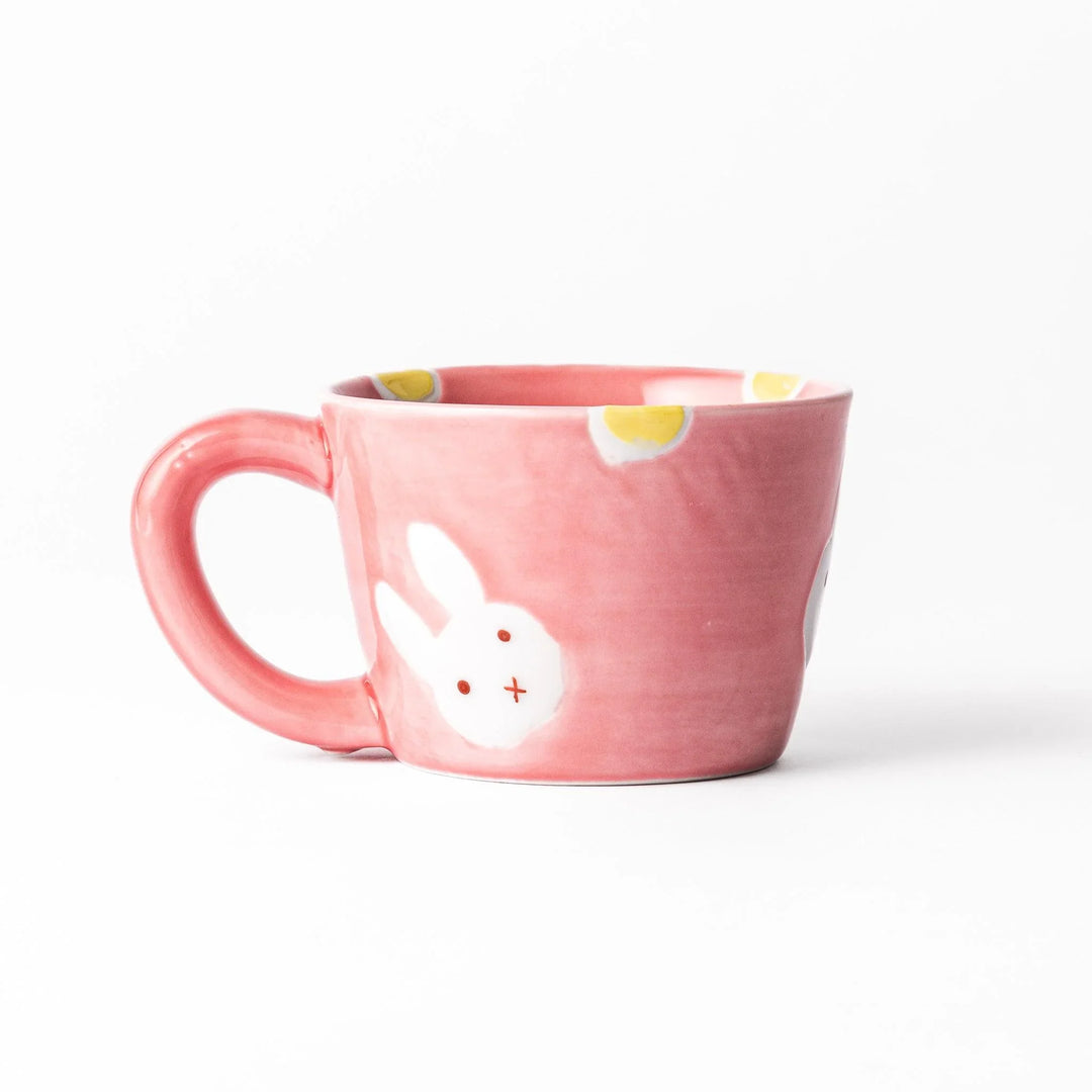 Pink kids’ mug with bunny design and yellow accents, adding a bright, fun touch to children’s tableware.
