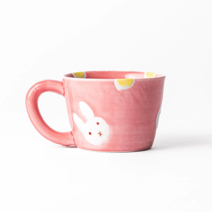 Pink kids’ mug with bunny design and yellow accents, adding a bright, fun touch to children’s tableware.