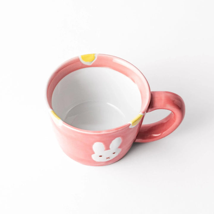 Pink kids’ mug with bunny design and yellow accents, adding a bright, fun touch to children’s tableware.