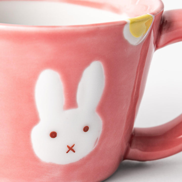 Pink kids’ mug with bunny design and yellow accents, adding a bright, fun touch to children’s tableware.