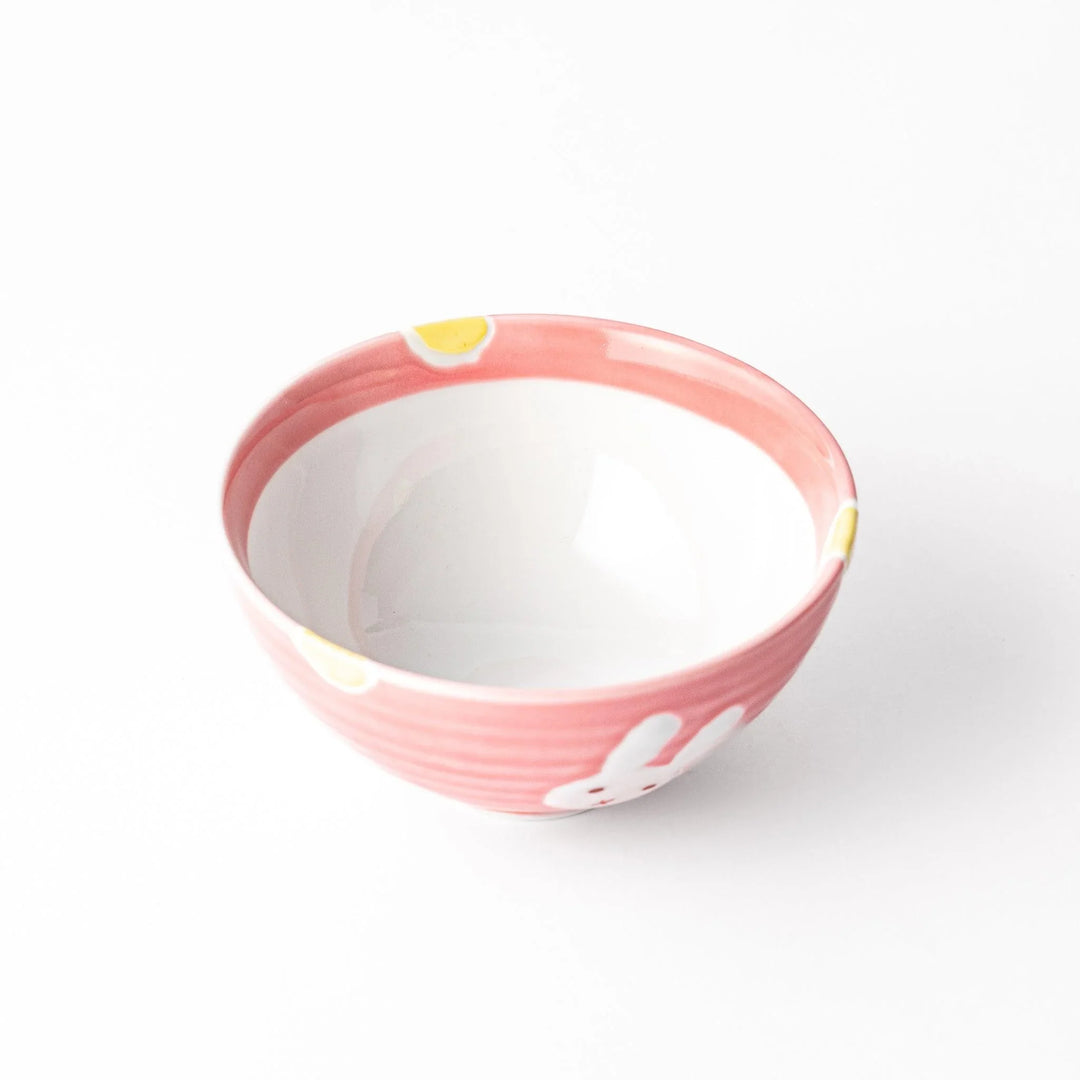 Pink kids’ rice bowl with cute bunny illustration and yellow accents, ideal for playful mealtime moments.