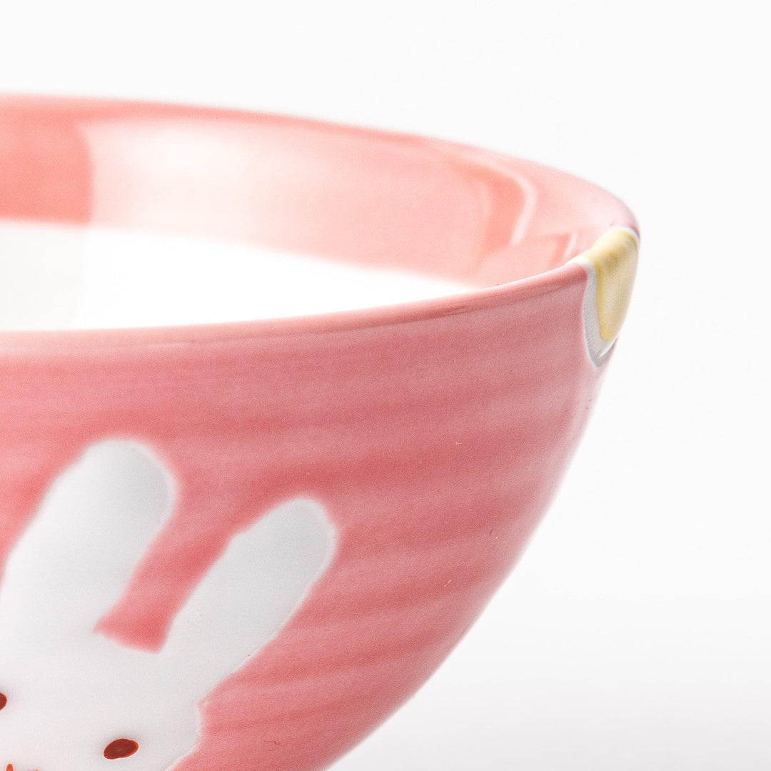 Pink kids’ rice bowl with cute bunny illustration and yellow accents, ideal for playful mealtime moments.