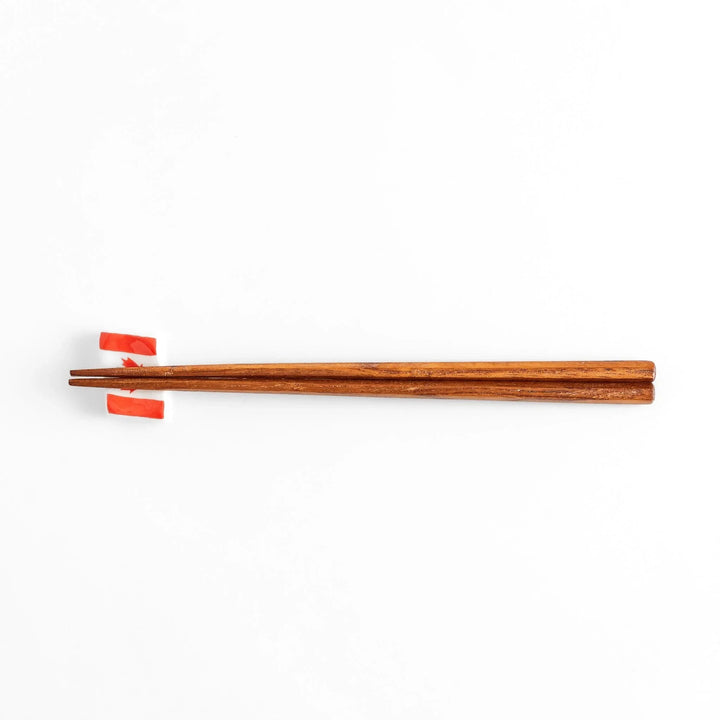 Chopstick rest shaped like the Canadian flag, featuring a red maple leaf in the center, with red borders on each side.