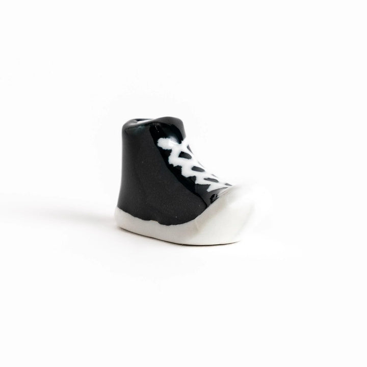 Canvas sneaker shaped ceramic chopstick rest featuring detailed laces and sole design adding playful touch to dining.