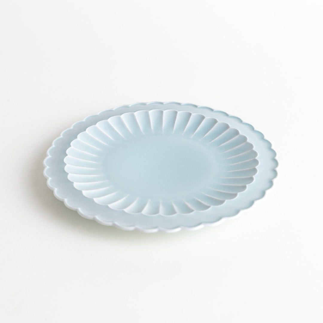 Fluted ceramic salad plate in matte black and light blue.