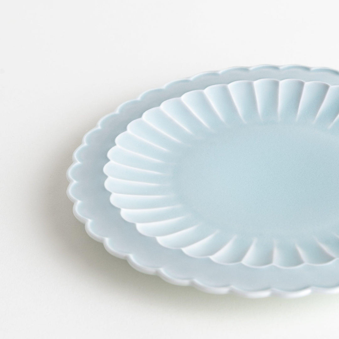 Fluted ceramic salad plate in matte black and light blue.